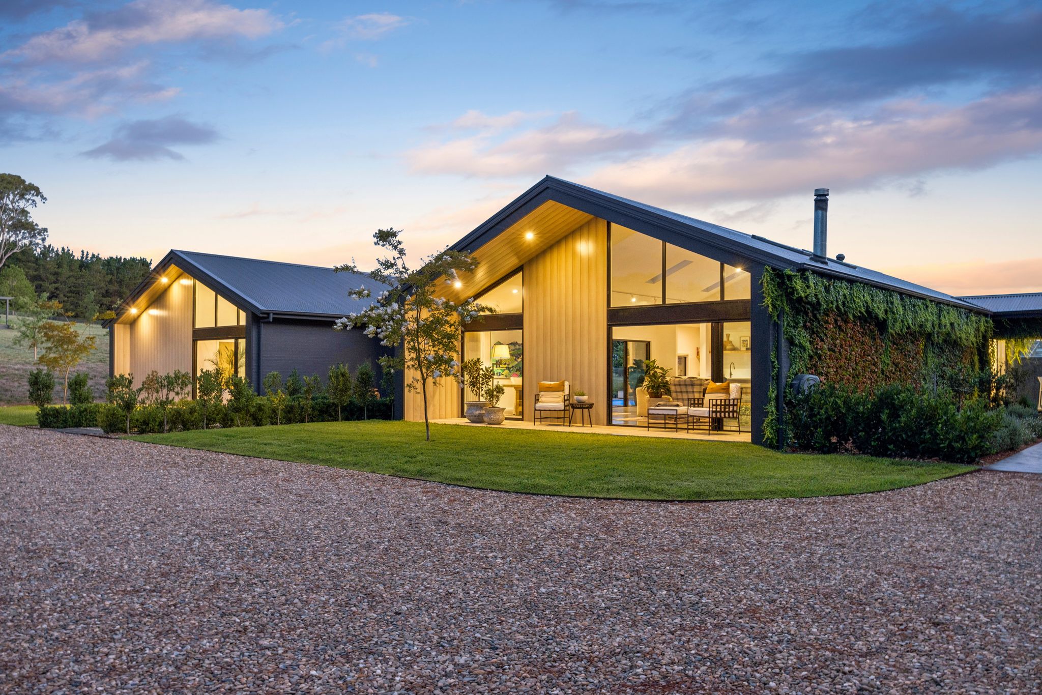 A modern Goulburn home with a pool, glowing at dusk